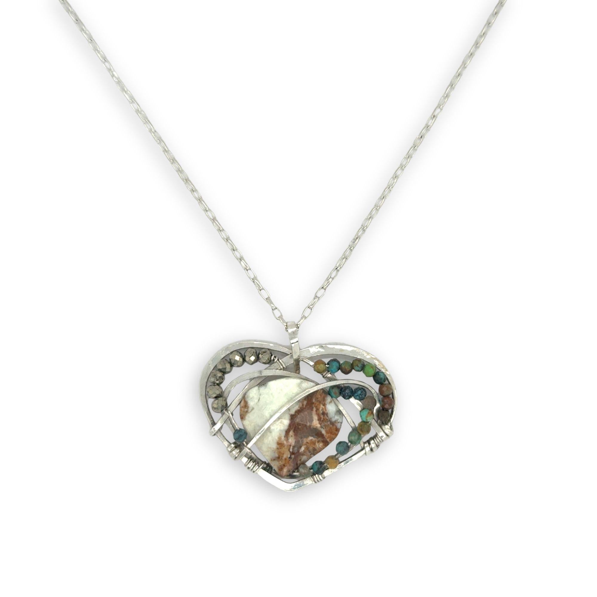 Necklace with a heart-shaped sterling silver hammered pendant featuring a gaspeite, turquoise, and pyrite gemstones