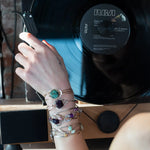 a turquoise smooth coin gemstone set in a hammered brass cuff bracelet, featuring a hand-formed clasp.