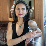 a turquoise smooth coin gemstone set in a hammered brass cuff bracelet, featuring a hand-formed clasp.