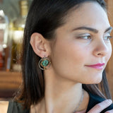 Flower stamped darkened sterling silver hoops with smooth turquoise coins held in hammered brass wire with built in earring hooks that wear like a post style earring