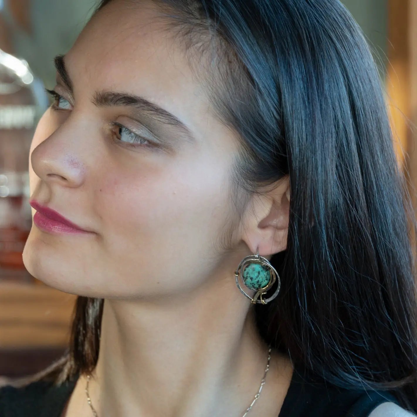 Flower stamped darkened sterling silver hoops with smooth turquoise coins held in hammered brass wire with built in earring hooks that wear like a post style earring
