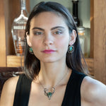 Flower stamped darkened sterling silver hoops with smooth turquoise coins held in hammered brass wire with built in earring hooks that wear like a post style earring