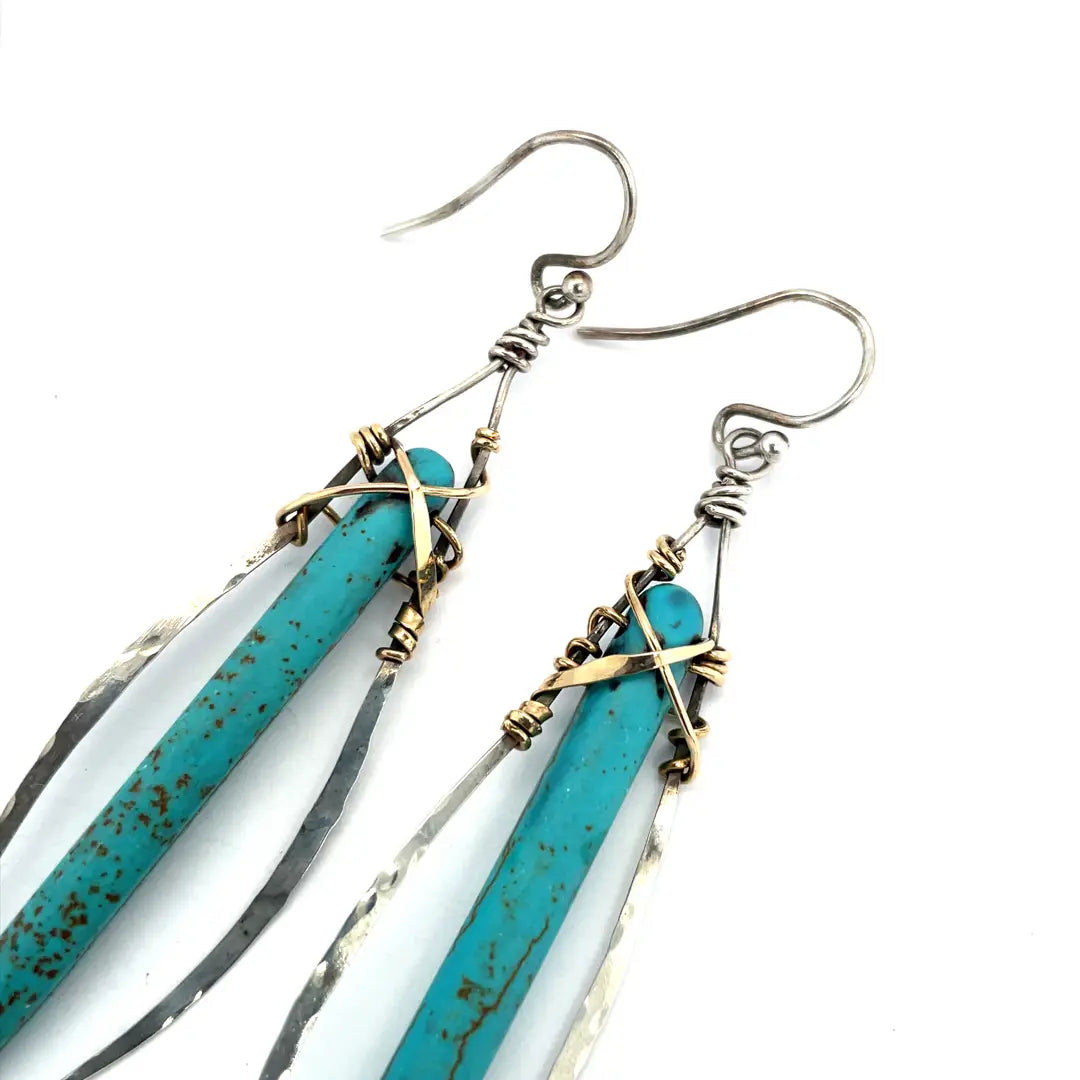 A pair of sterling silver skinny marquise earrings with turquoise stalactite on brass wire with bright blue crystal accent
