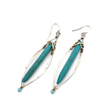 A pair of sterling silver skinny marquise earrings with turquoise stalactite on brass wire with bright blue crystal accent
