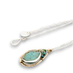 Floral stamped bronze drop pendant filled with turquoise gemstones, hammered sterling silver, and 14k gold filled wire on a sterling silver chain necklace