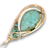 Floral stamped bronze drop pendant filled with turquoise gemstones, hammered sterling silver, and 14k gold filled wire on a sterling silver chain necklace