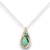 Floral stamped bronze drop pendant filled with turquoise gemstones, hammered sterling silver, and 14k gold filled wire on a sterling silver chain necklace