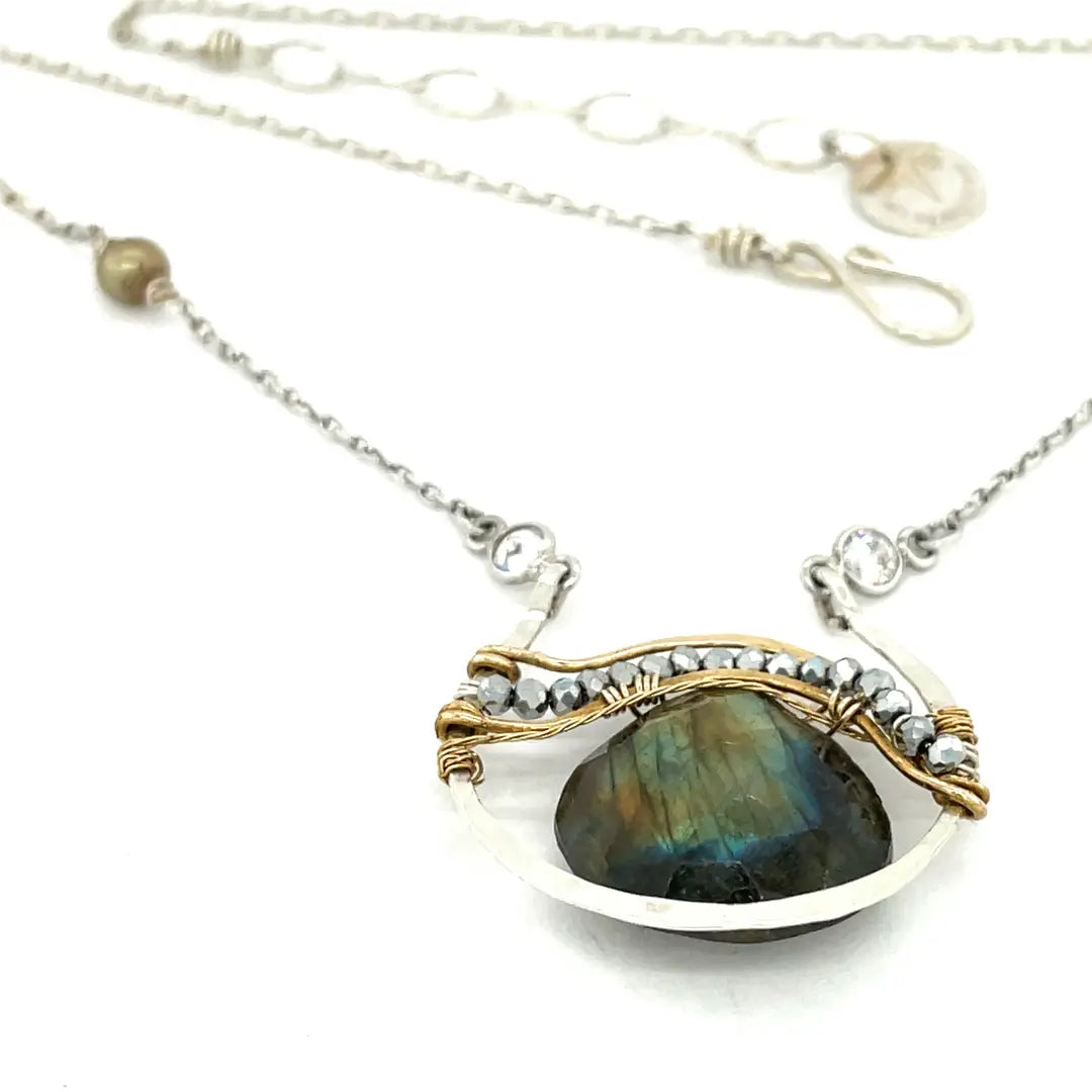 Sterling silver necklace with flashy labradorite drop gemstone and pyrite between swishes of brass wire on a delicate sterling chain with fresh water pearl accents
