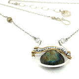 Sterling silver necklace with flashy labradorite drop gemstone and pyrite between swishes of brass wire on a delicate sterling chain with fresh water pearl accents