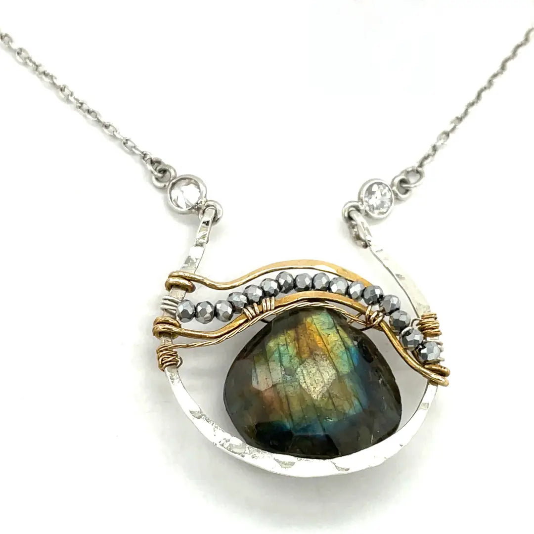 Sterling silver necklace with flashy labradorite drop gemstone and pyrite between swishes of brass wire on a delicate sterling chain with fresh water pearl accents