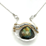 Sterling silver necklace with flashy labradorite drop gemstone and pyrite between swishes of brass wire on a delicate sterling chain with fresh water pearl accents