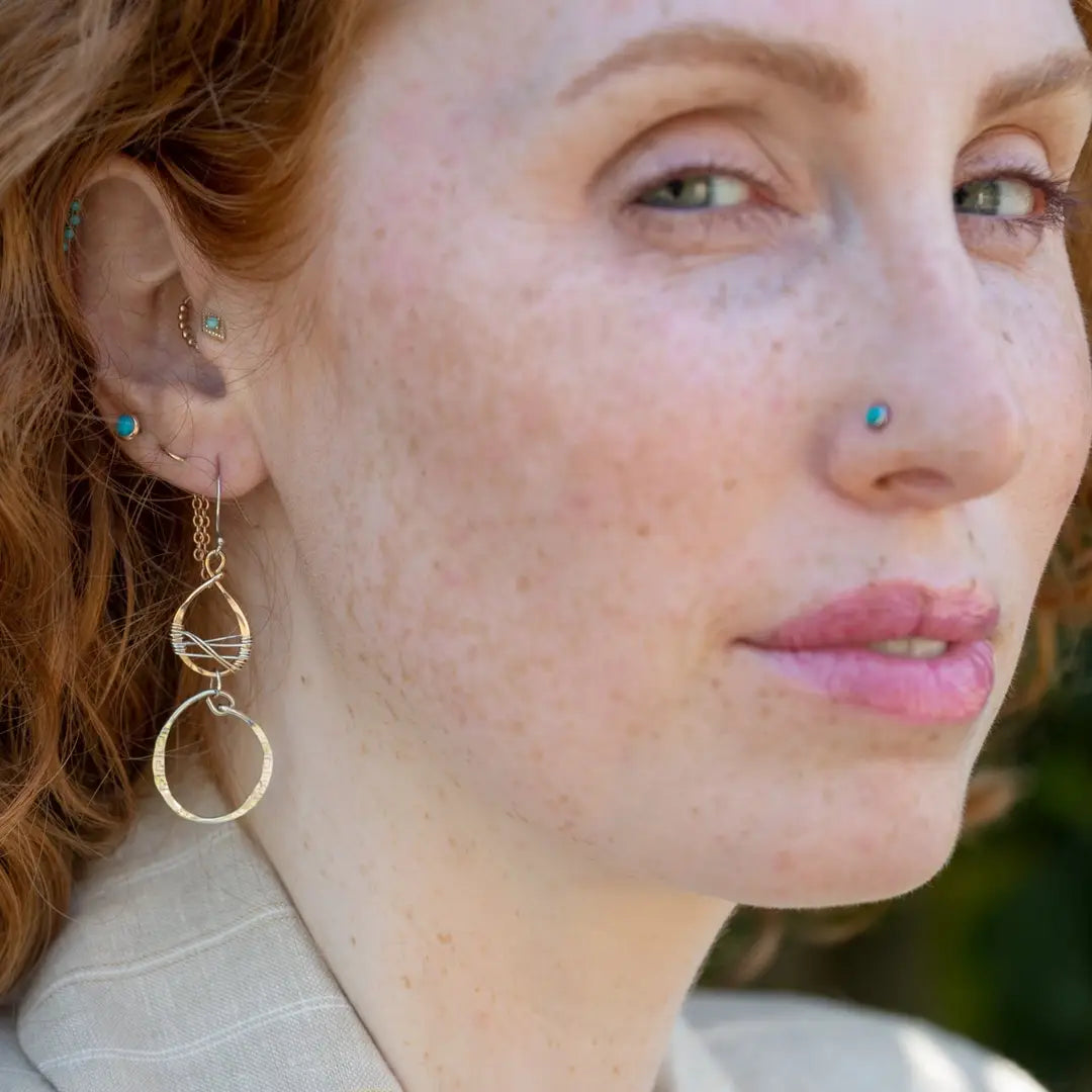 Handmade stamped sterling silver hoops hanging from bronze drops braided with sterling silver fine wire