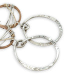 Handmade stamped sterling silver hoops hanging from bronze drops braided with sterling silver fine wire