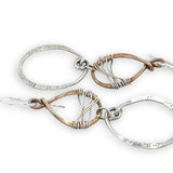 Handmade stamped sterling silver hoops hanging from bronze drops braided with sterling silver fine wire