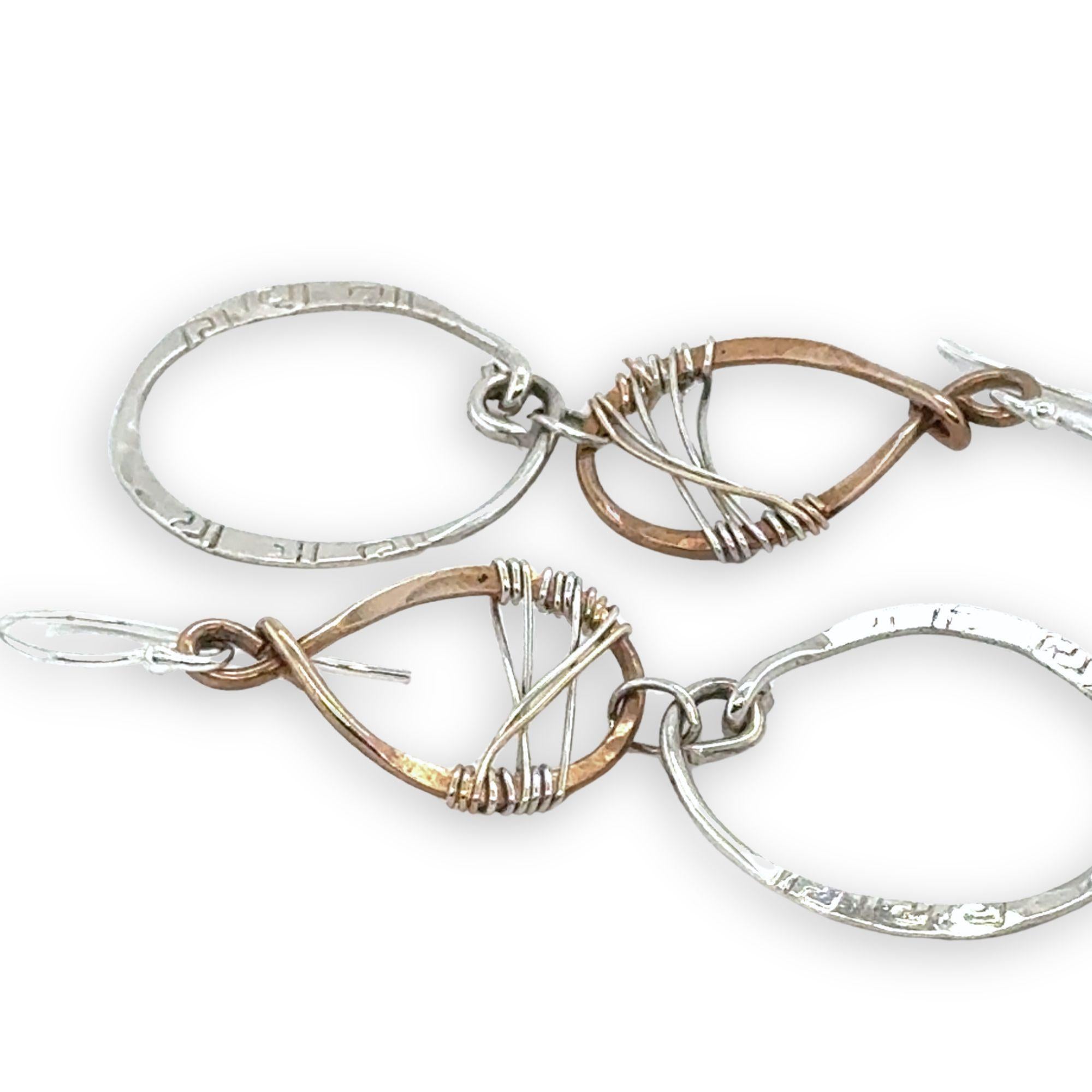 Handmade stamped sterling silver hoops hanging from bronze drops braided with sterling silver fine wire