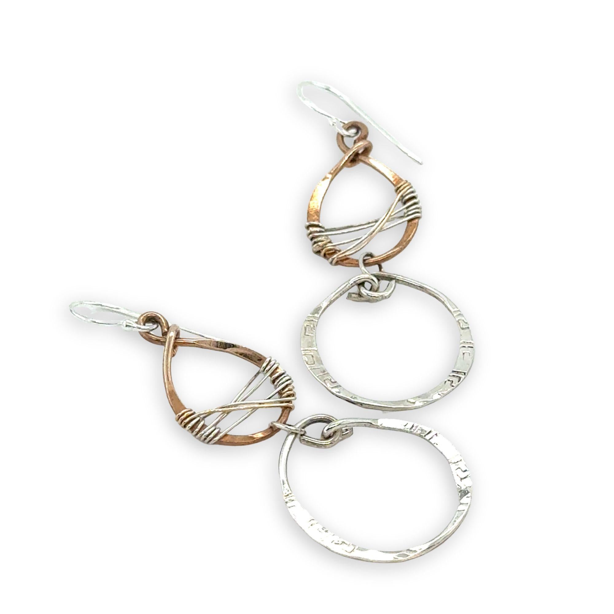 Handmade stamped sterling silver hoops hanging from bronze drops braided with sterling silver fine wire