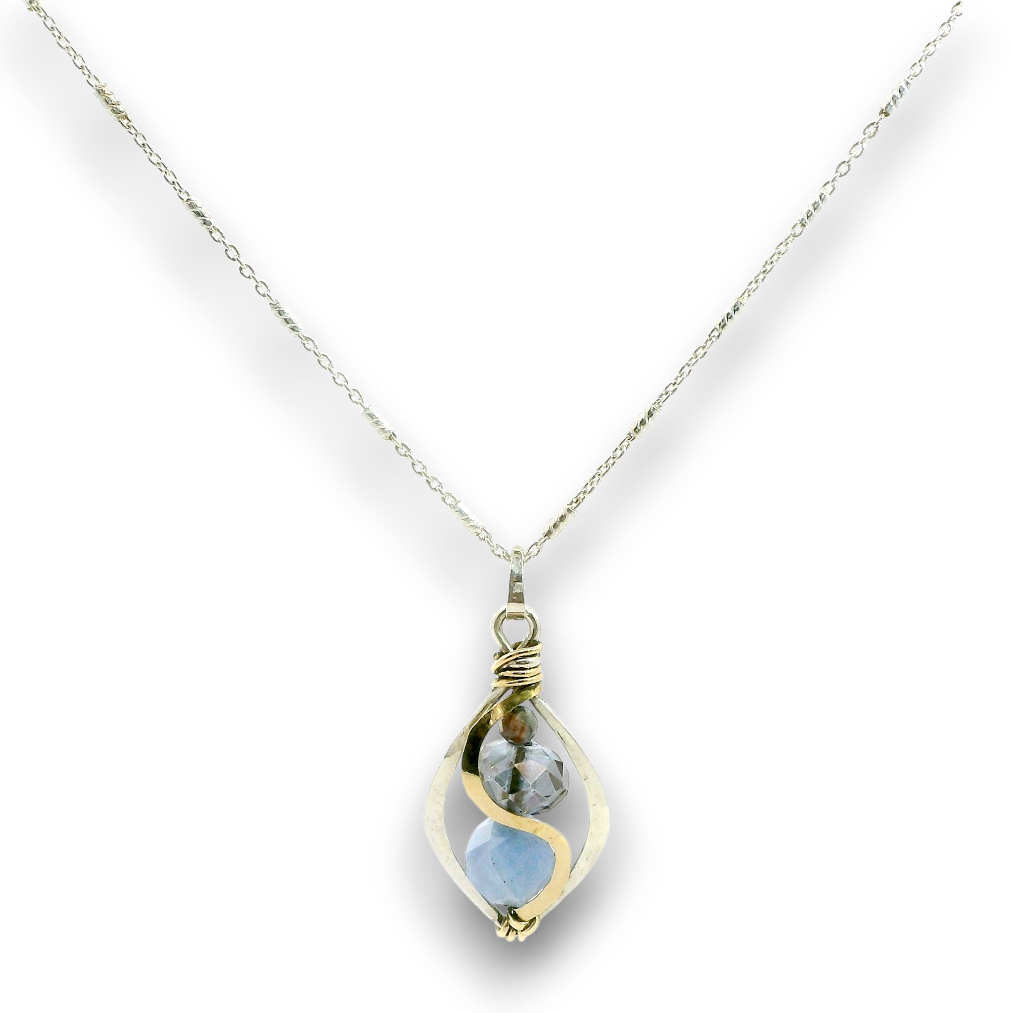Mini marquise sterling silver pendant necklace with sky blue jade, blue crystal, and aquamarine gemstones held in hammered brass wire on a dainty sterling silver chain