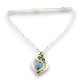 Mini marquise sterling silver pendant necklace with sky blue jade, blue crystal, and aquamarine gemstones held in hammered brass wire on a dainty sterling silver chain
