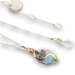 Mini marquise sterling silver pendant necklace with sky blue jade, blue crystal, and aquamarine gemstones held in hammered brass wire on a dainty sterling silver chain