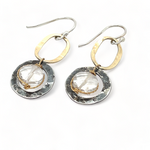 A pair of earrings featuring clear faceted quartz gemstones, oxidized sterling silver stamped rings on brass hammered handmade links.