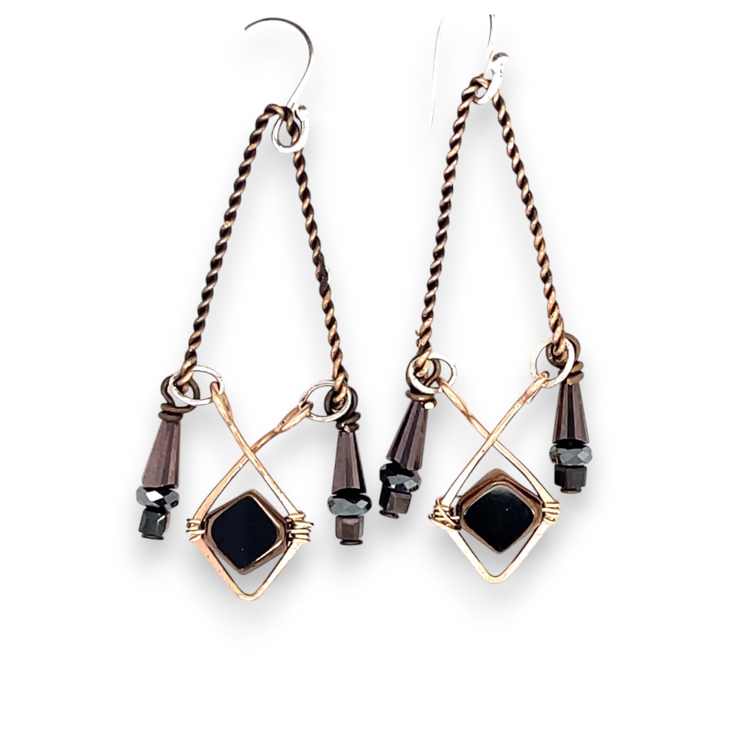 A pair of vintage style chandelier earrings with black glass and metallic crystal on bronze and twisted brass earring frames.