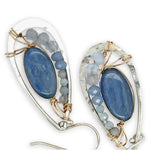 Sterling silver hammered drop earrings with smooth kyanite oval gemstones wrapped in gold fill wire surrounded by blue crystal, mini cat's eye, and blue lace agate gemstones
