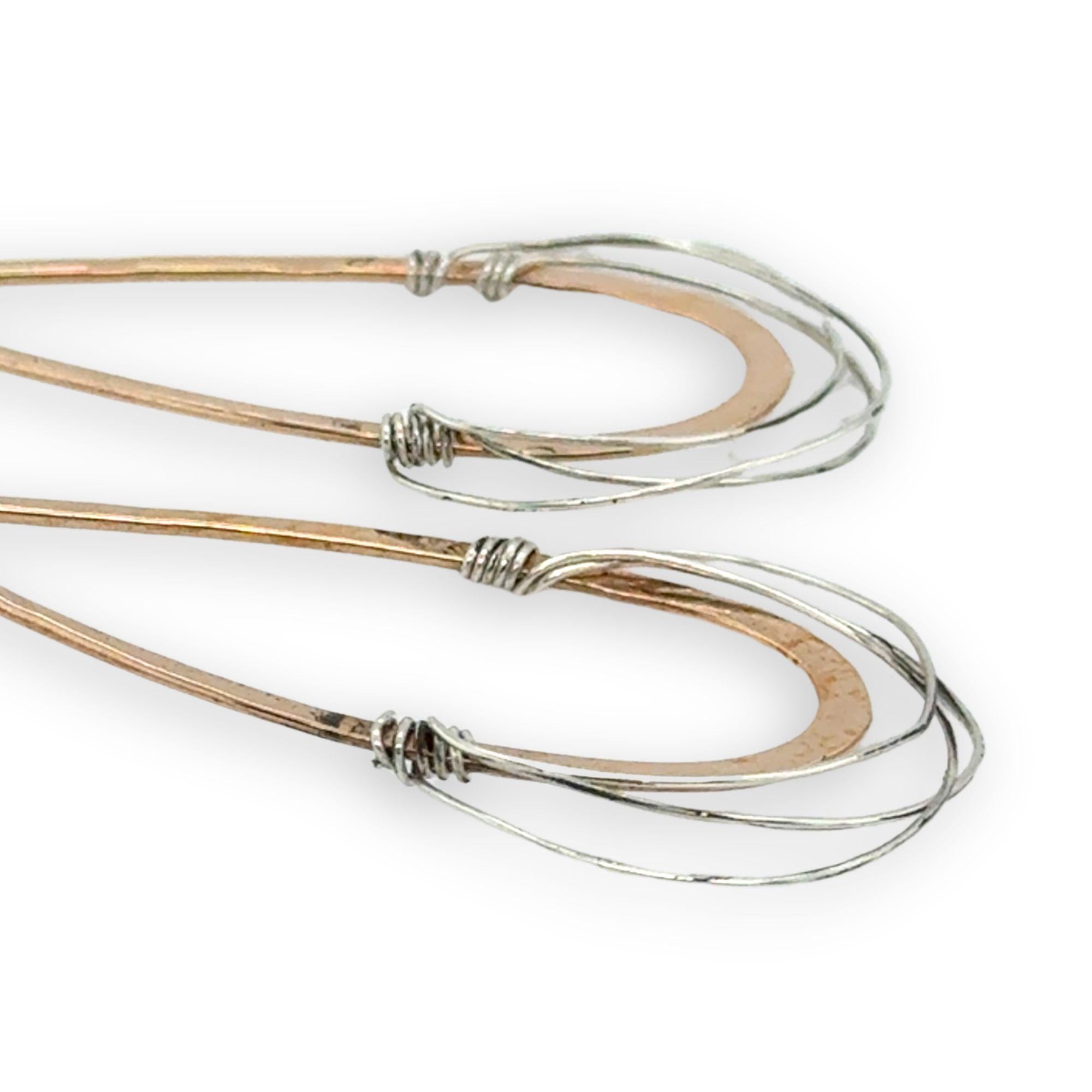 Bronze drop shaped earrings with sterling silver fine wire webbing on the bottom