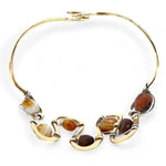 Banded brown/orange agate faceted coins are wrapped in sterling silver and gold filled wires attached to a winding river of brass hammered wire bracelet stamped with trees