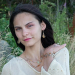 Banded brown/orange agate faceted coins are wrapped in sterling silver and gold filled wires attached to a winding river of brass hammered wire bracelet stamped with trees