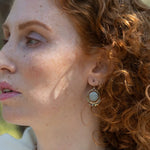 Smooth aquamarine coins are held within sterling silver mini hoops stamped with leaves with crystal accents