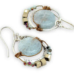 Smooth aquamarine coins are held within sterling silver mini hoops stamped with leaves with crystal accents
