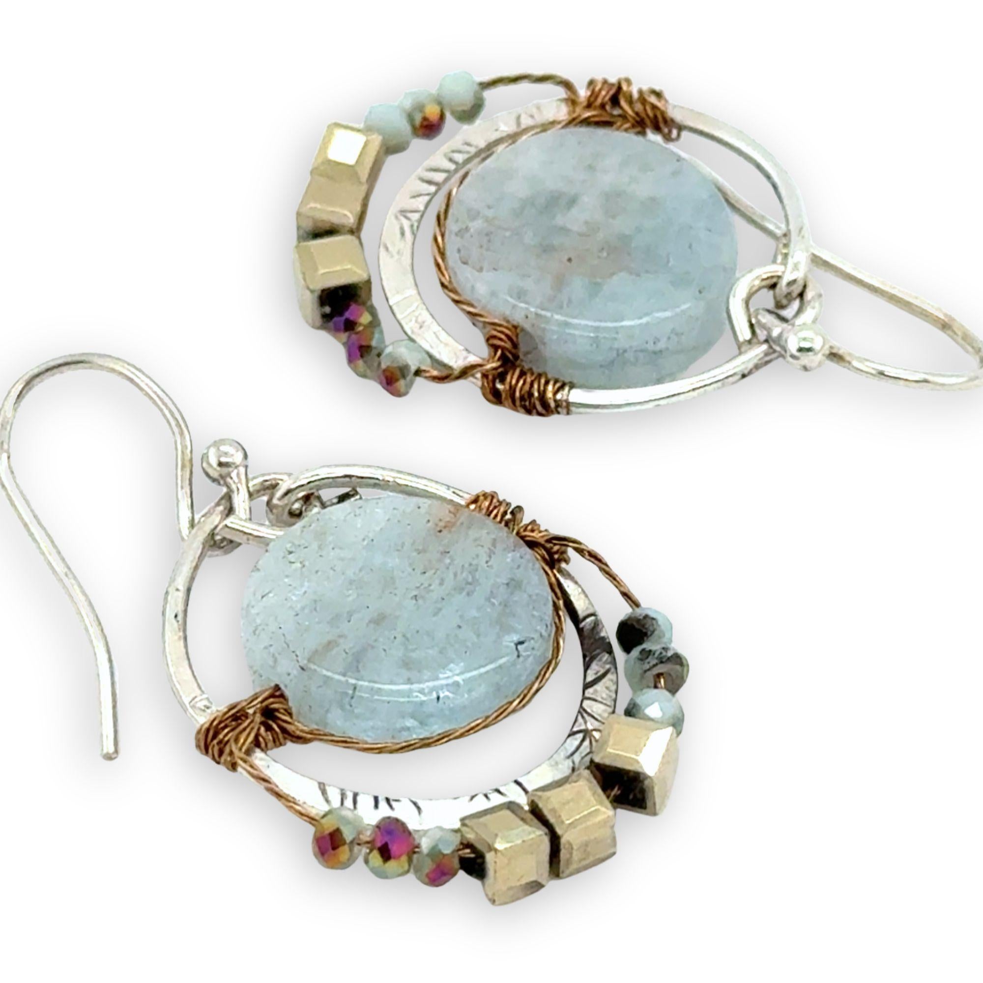 Smooth aquamarine coins are held within sterling silver mini hoops stamped with leaves with crystal accents