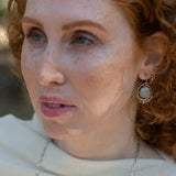 Smooth aquamarine coins are held within sterling silver mini hoops stamped with leaves with crystal accents