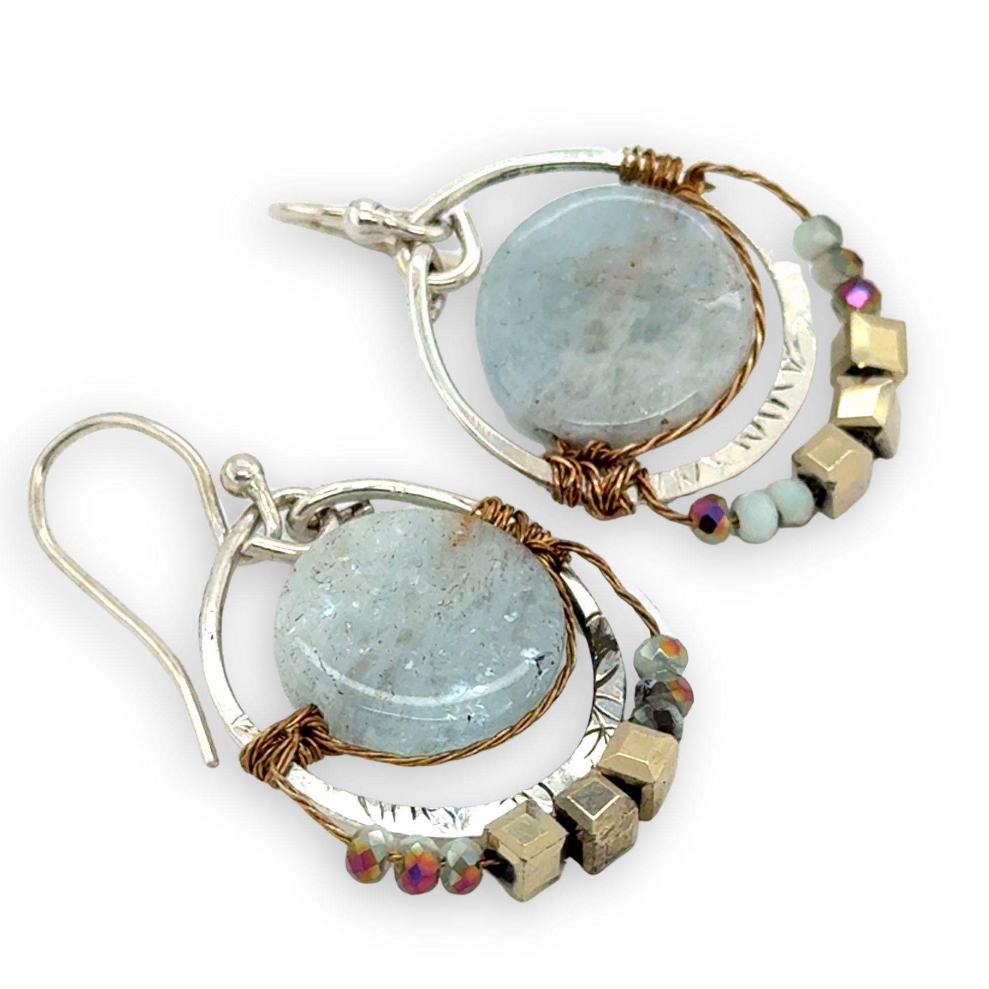Smooth aquamarine coins are held within sterling silver mini hoops stamped with leaves with crystal accents
