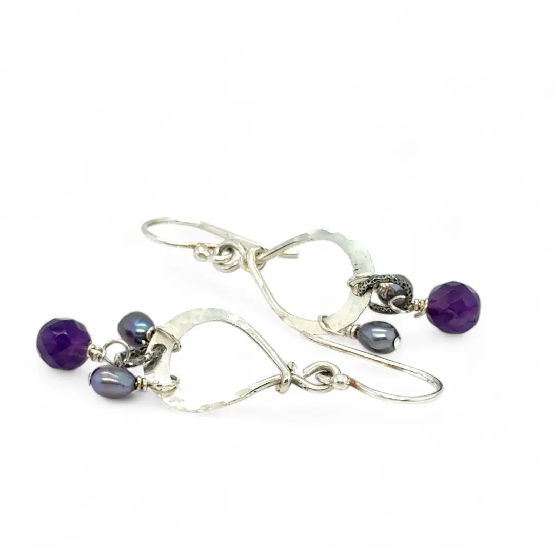 A pair of sterling silver mini drop earrings featuring faceted spherical amethyst and purple freshwater pearl accents