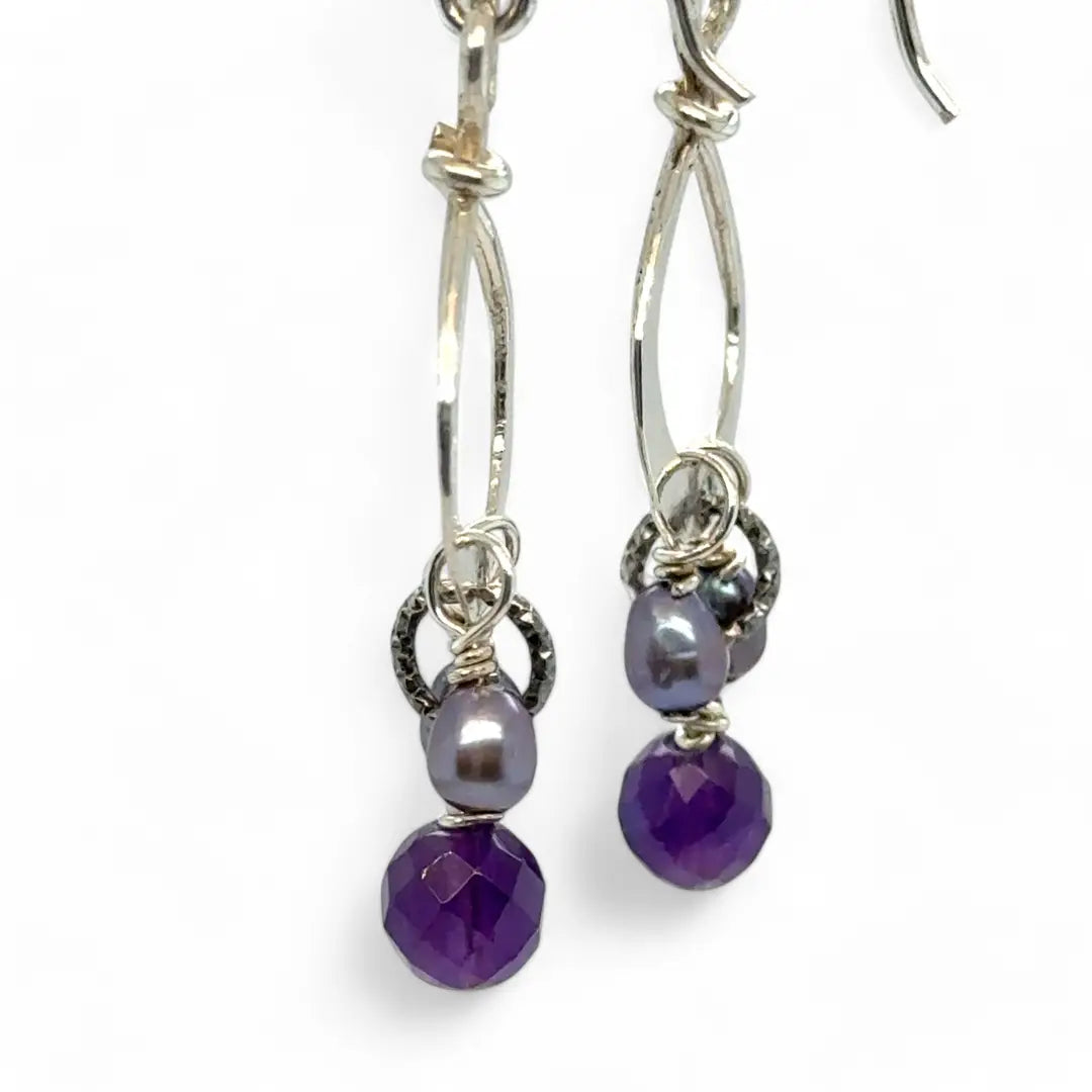 A pair of sterling silver mini drop earrings featuring faceted spherical amethyst and purple freshwater pearl accents