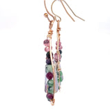 Ruby zoisite and cherry quartz surround layered of gold filled wire and pink crystal inside a bronze drop earring