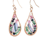 Ruby zoisite and cherry quartz surround layered of gold filled wire and pink crystal inside a bronze drop earring