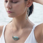 Handmade aqua cat's eye and labradorite drop earrings with sterling silver and bronze worn on model -Art by any Means Jewelry