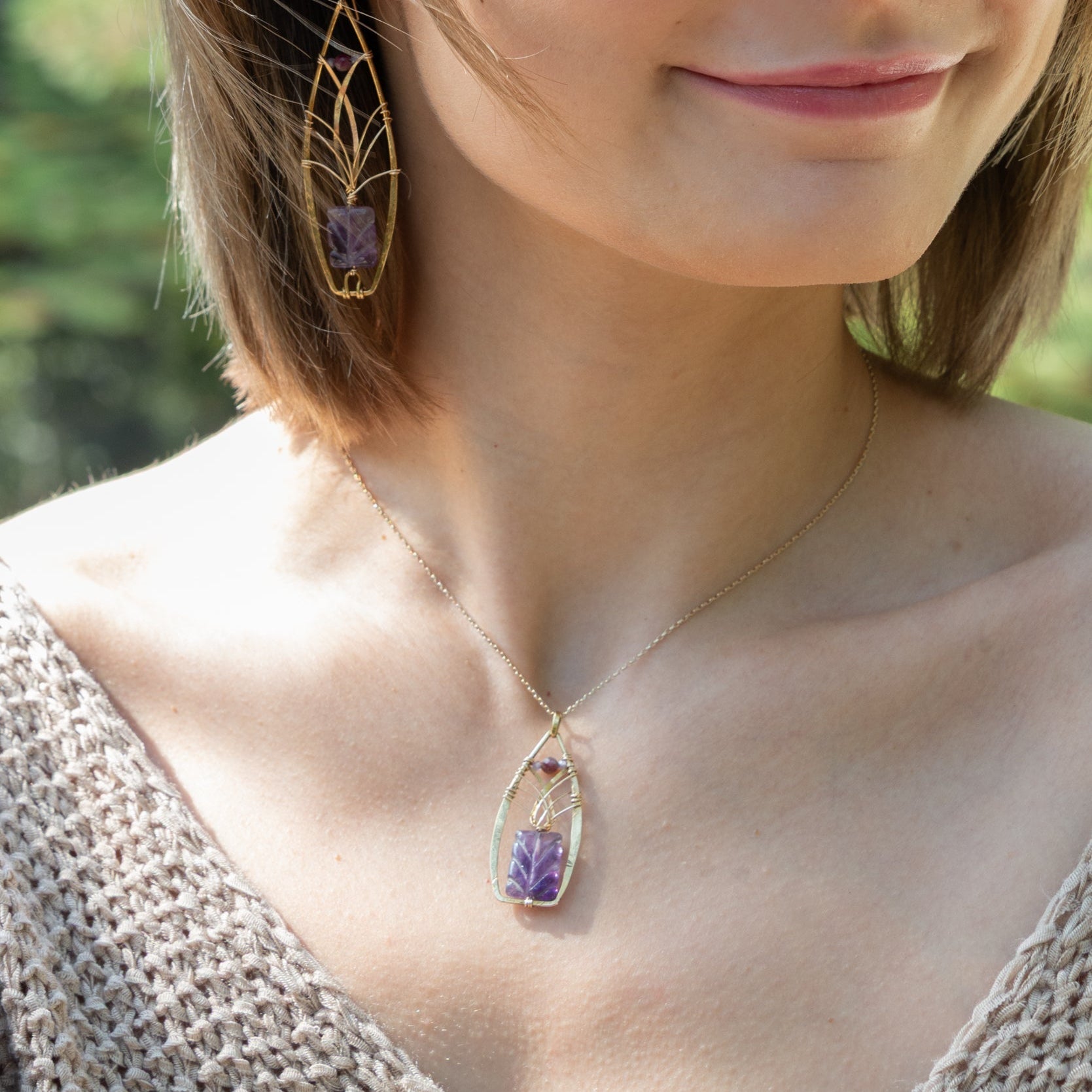 Handmade pendant necklace featuring a carved amethyst gemstone, by Art by any Means Jewelry