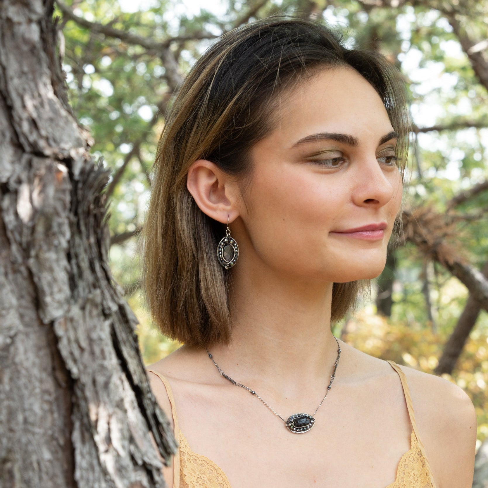 Handmade necklace featuring a coin-shaped tourmaline gemstone, by Art by any Means Jewelry