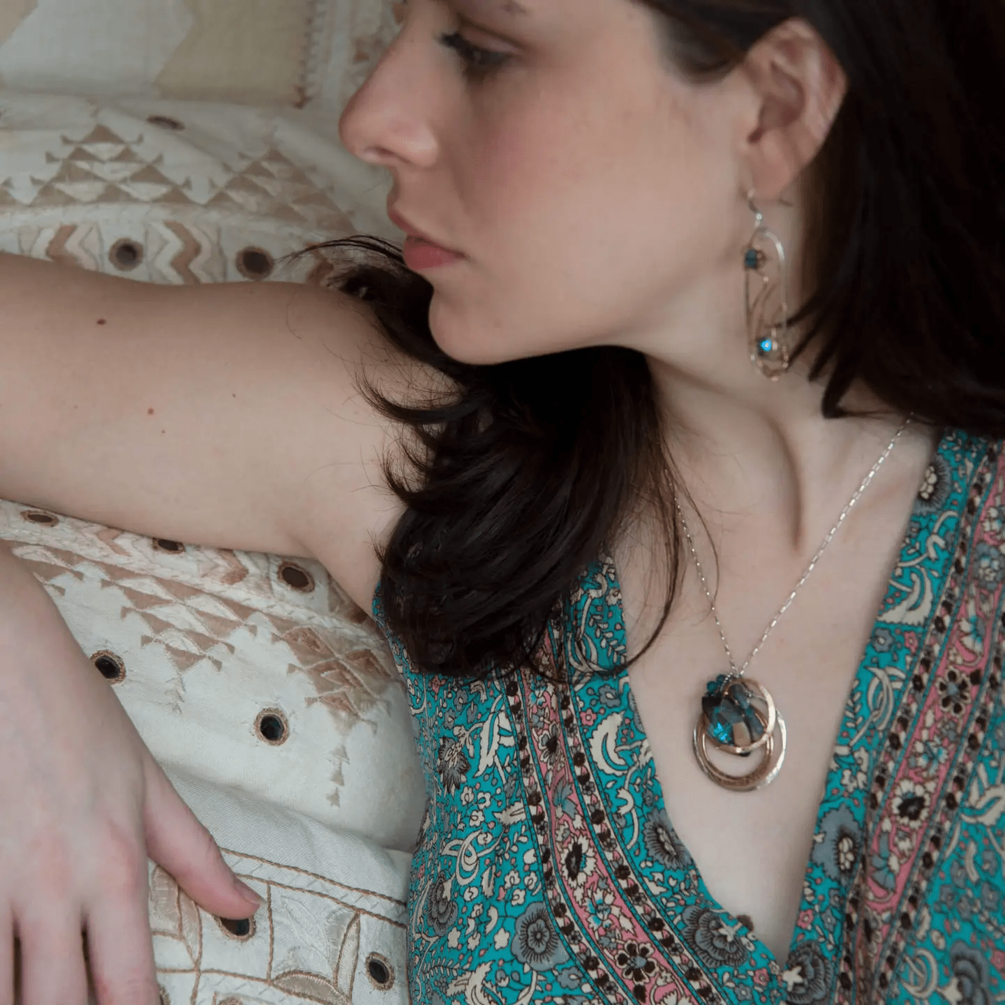Large blue crystal in layers of brass and sterling silver nested wire, sodalite gemstones, and brass twist wire accents