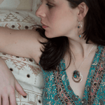 Large blue crystal in layers of brass and sterling silver nested wire, sodalite gemstones, and brass twist wire accents