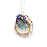 Large blue crystal in layers of brass and sterling silver nested wire, sodalite gemstones, and brass twist wire accents