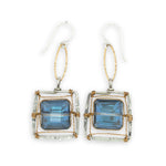 Faceted blue crystal tiles tight in brass twist wire in a stamped sterling silver box earring, hanging from gold filled link