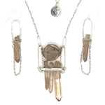 Handformed sterling silver arch with delicate sterling silver chain and natural quartz point detail Art by any Means Jewelry