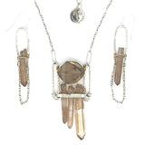 Handformed sterling silver arch with delicate sterling silver chain and natural quartz point detail Art by any Means Jewelry