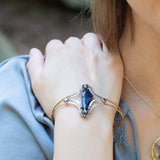 Handmade hammered brass cuff bracelet with a faceted sodalite teardrop and pyrite gemstones, by Art by any Means Jewelry