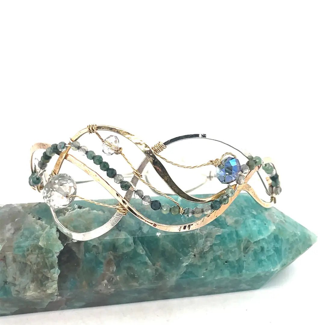 moss agate, green amethyst, crystal, waves of hammered brass, bronze, and sterling silver to form a braided cuff bracelet