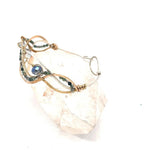 moss agate, green amethyst, crystal, waves of hammered brass, bronze, and sterling silver to form a braided cuff bracelet